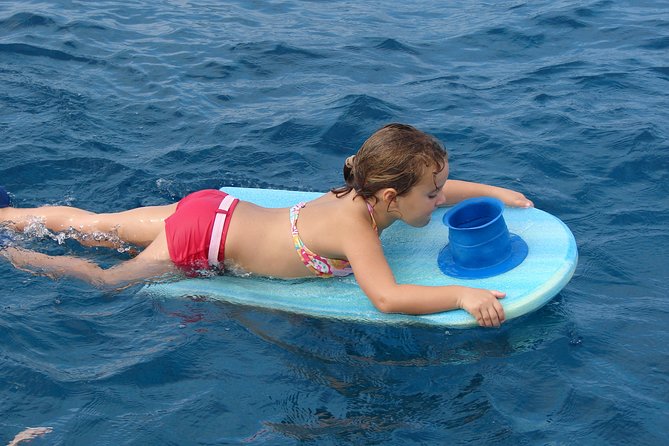Deluxe Snorkel & Dolphin Watch Aboard a Luxury Catamaran from Kailua-Kona - The onboard fun: slide, high jump, and water toys